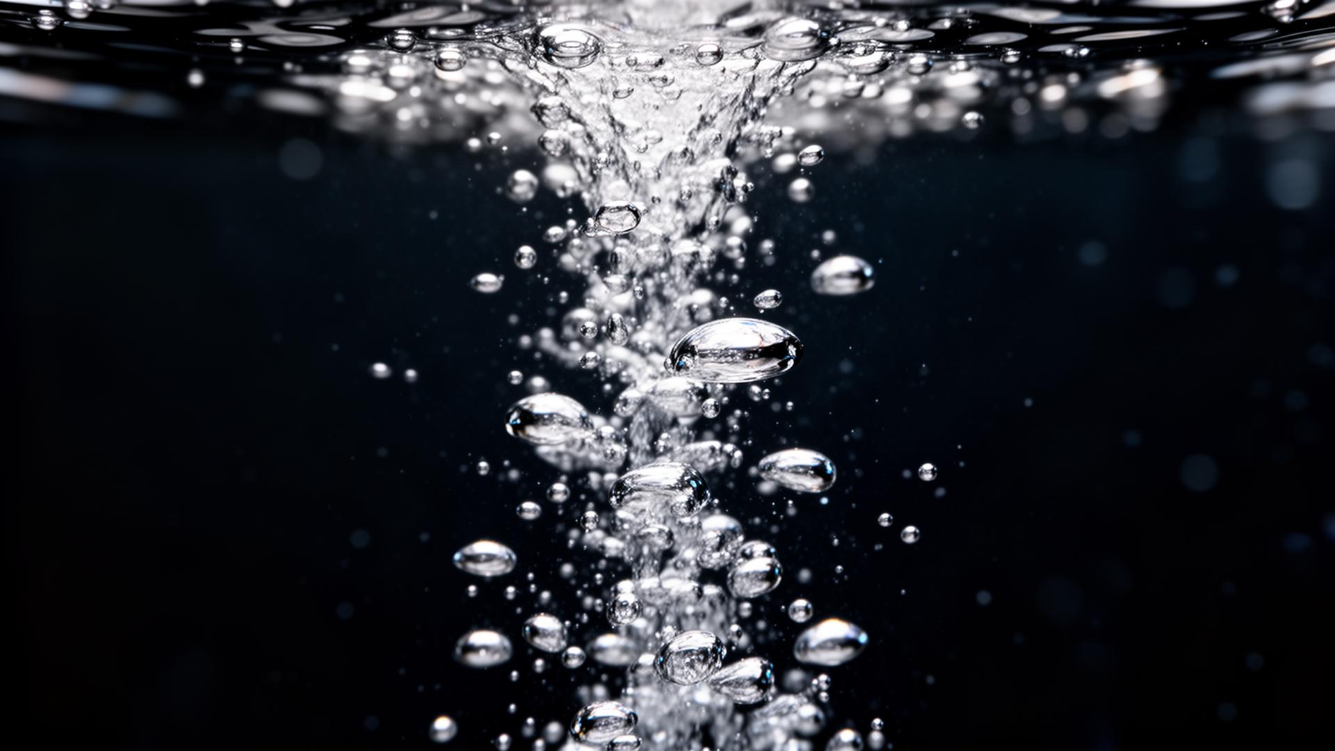 Cold sparkling carbonation rising in dark liquid